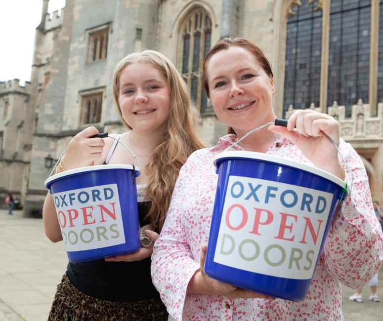 Two volunteers with donation buckets at Magdalen College