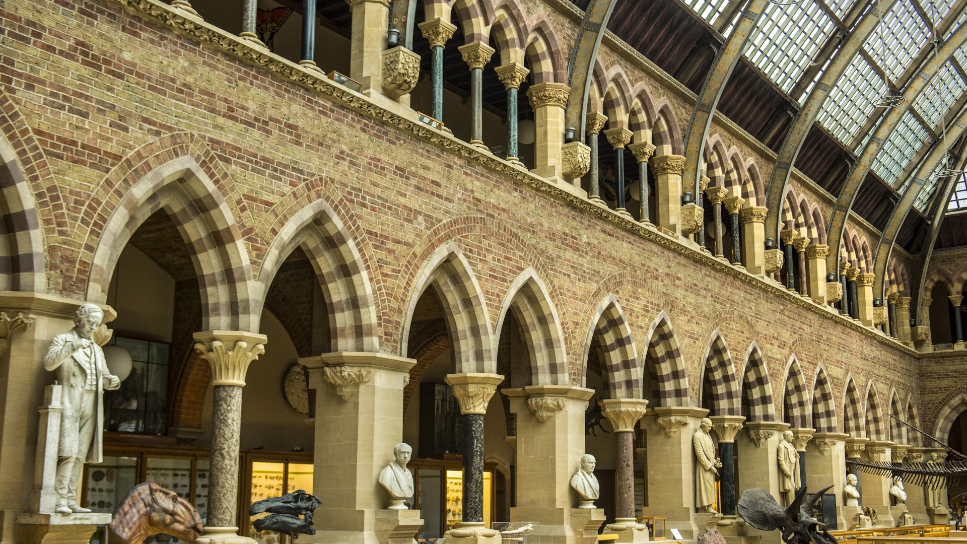 The interior of a Victorian brick building with striped arches and an ironwork roof.