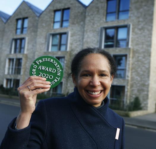 woman holding OPT plaque