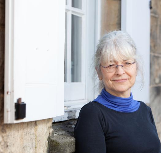 Anna Eavis standing in front of OPT offices