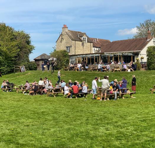People sat in sunny Victoria Arms pub garden