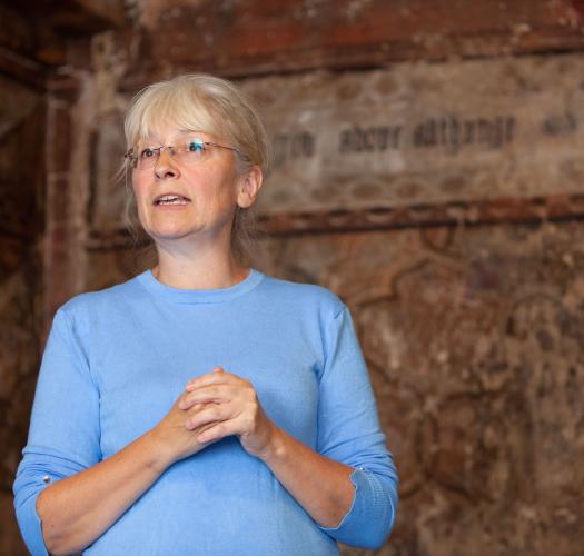 Woman stood in front of wall paintings
