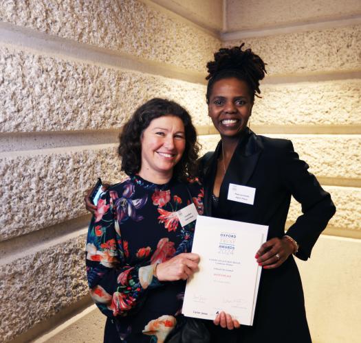 Two women holding a certificate