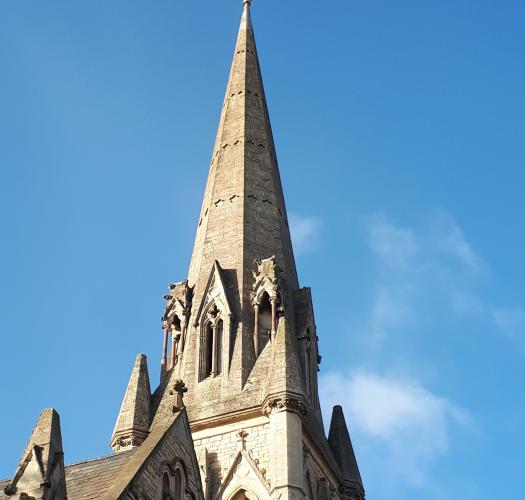 The pointed spire of a stone church