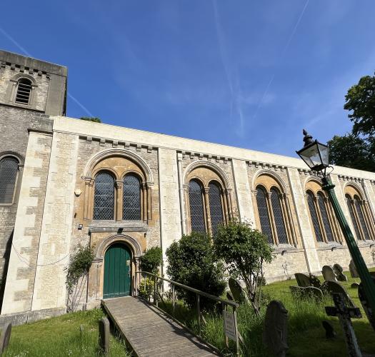 A church with rounded arched windows and a tower.