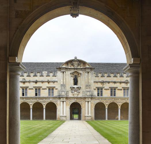 A seventeenth-century stone quadrangle viewed from beneath an entrance arch.