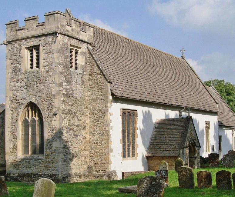 A church with a stone tower and white walls.