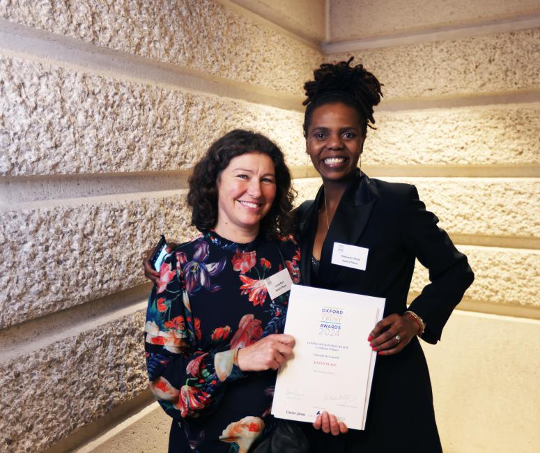 Two women holding a certificate