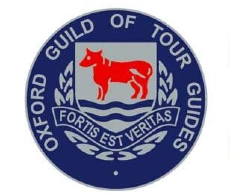 A blue circle with a grey crest displaying a red ox over water. The inscription reads Oxford Guild of Tour Guides