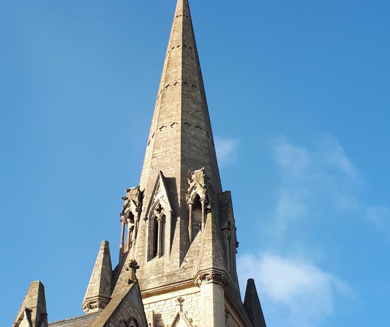 The pointed spire of a stone church