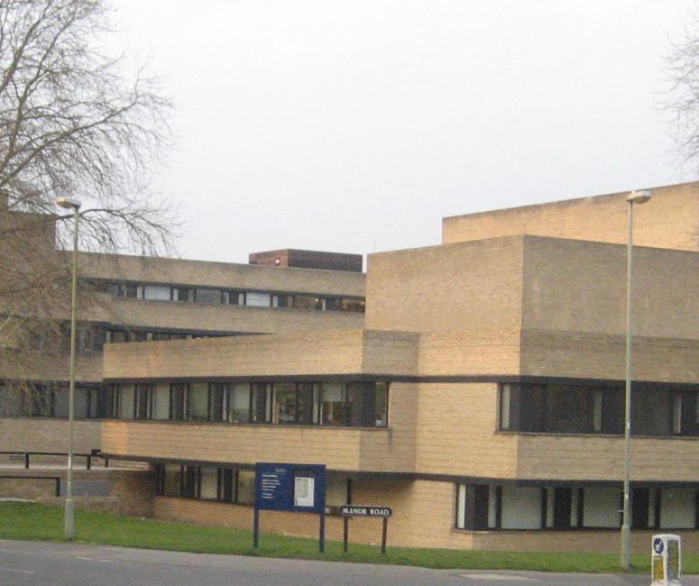 A large but low-height modern brick building composed of rectangular shapes and right angles.