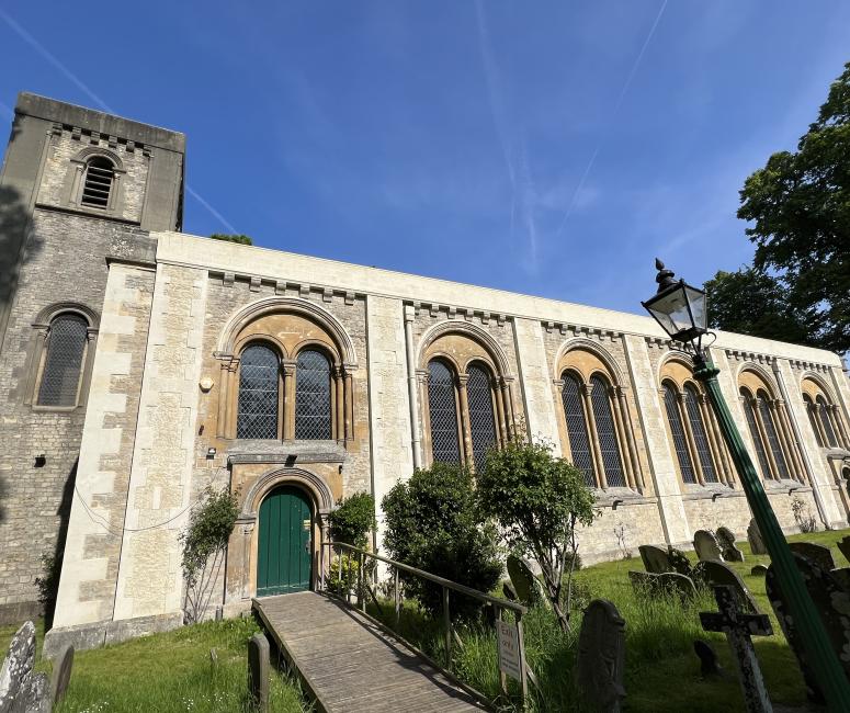 A church with rounded arched windows and a tower.