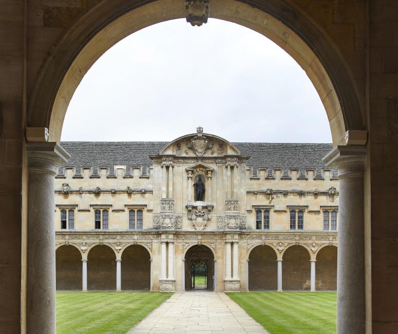 A seventeenth-century stone quadrangle viewed from beneath an entrance arch.