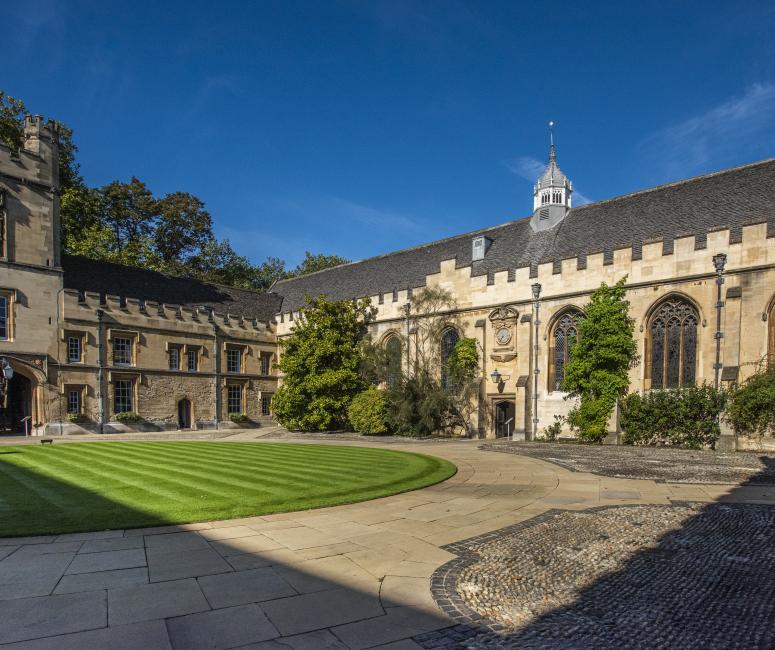 A stone quadrangle with a circular lawn.