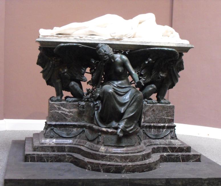 A marble monument with the effigy of a young drowned man and a weeping female figure below.