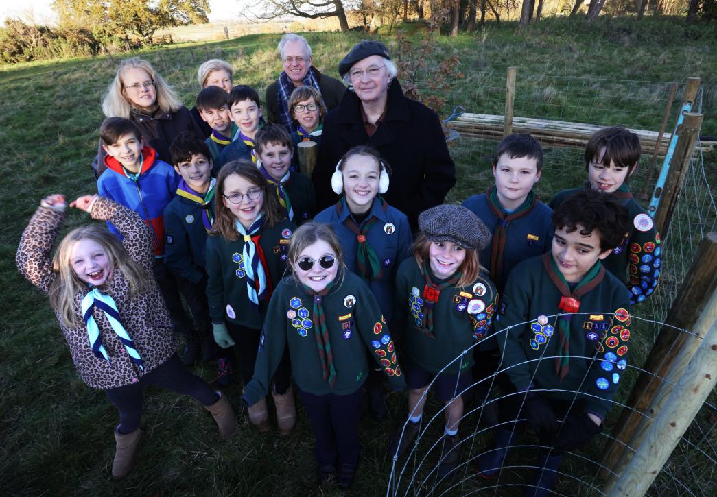 Philip Pullman with tree and children in the background