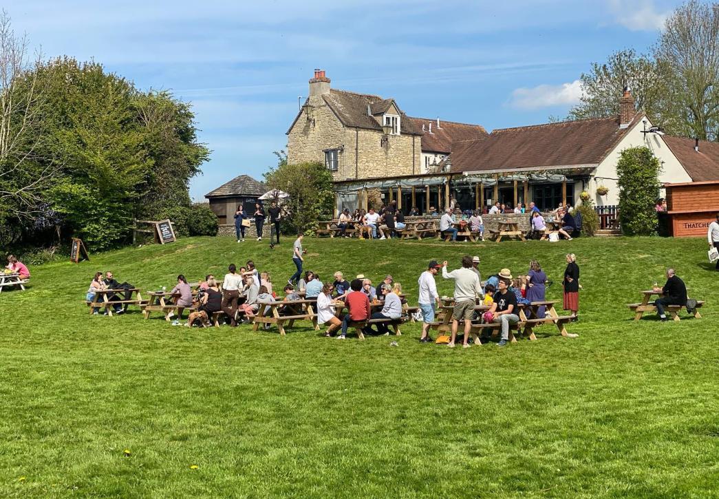 People sat in sunny Victoria Arms pub garden