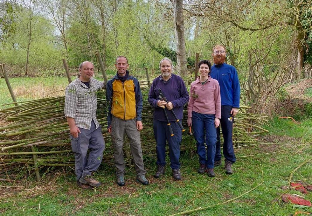 Some people stood in front of a bird hide